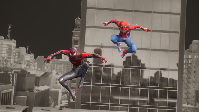 Miles Morales and Peter Parker, Spider-Men, jump towards the screen in front of a monochromatic background.