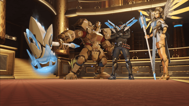 Reinhardt, Reaper, and Mercy all stand with their Hard Light weapons.